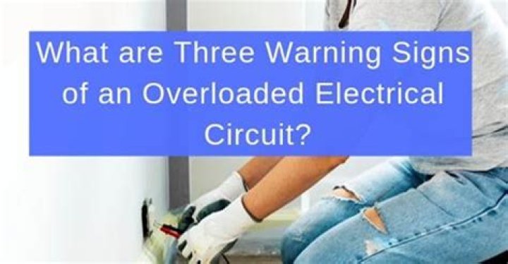 What are three warning signs of an overloaded electrical circuit?